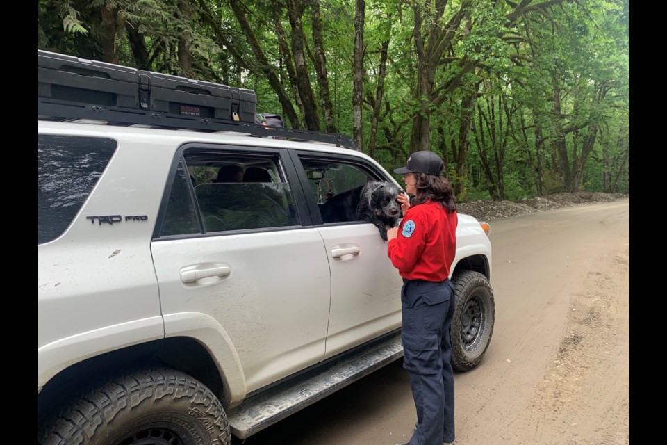 Kimberly Kelly, an information officer with the BC Wildfire Service, chats with a driver at the entrance to the Upper Squamish Valley on Friday evening. 