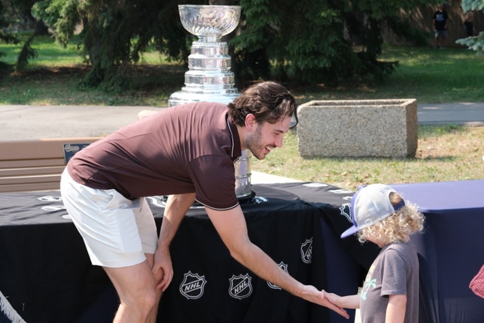 Mahura high-fiving a young fan. GARRETKRYZANOWSKI/ St. Albert Gazette 