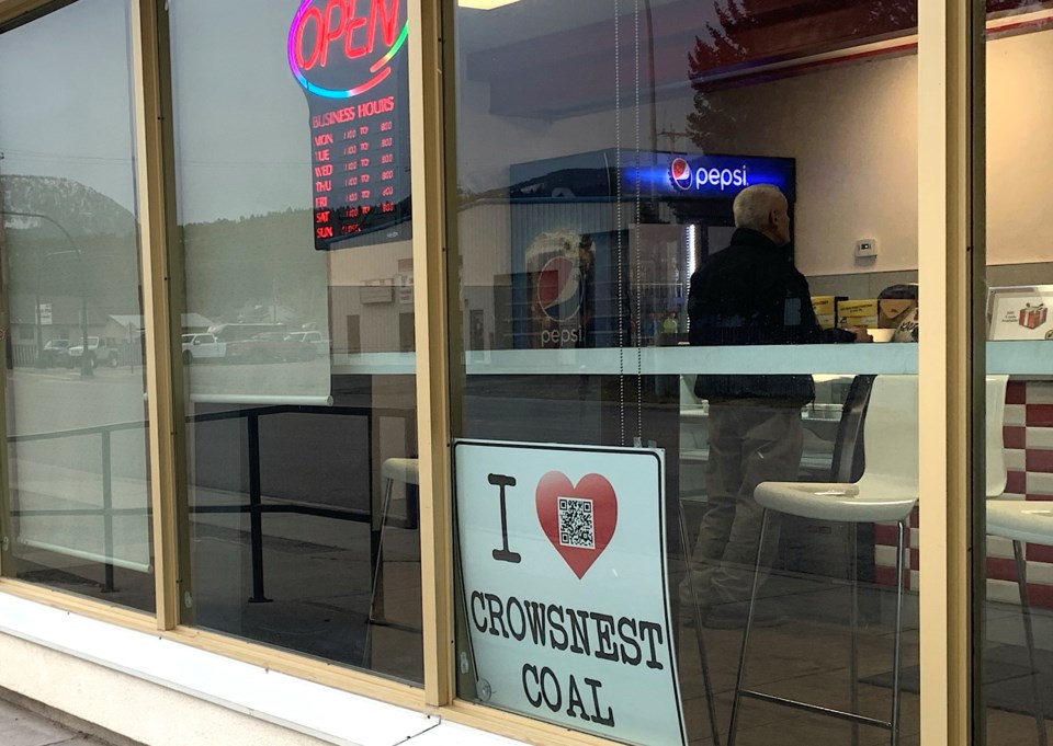 An "I (heart) Crowsnest Coal sign is seen in a shop window in Blairmore, Alta.