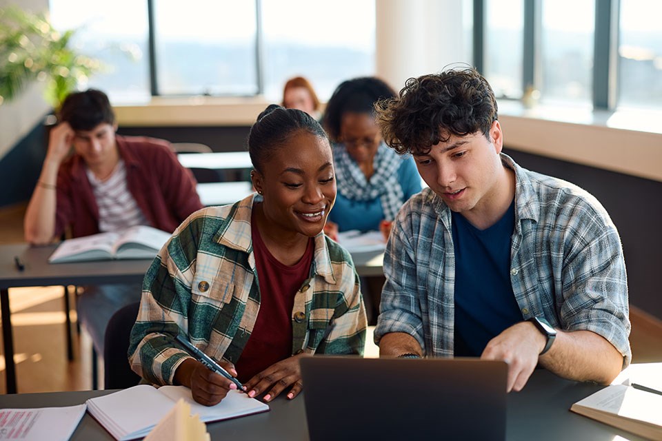 happy-multiracial-students-e-learning-on-laptop-wh-2024-12-13-18-18-58-utc