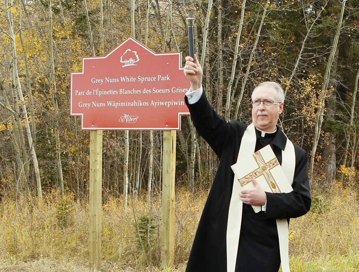 Archbishop Richard Smith of the Catholic Archdiocese of Edmonton sprinkles holy water to bless the newly-named Grey Nuns White Spruce Park