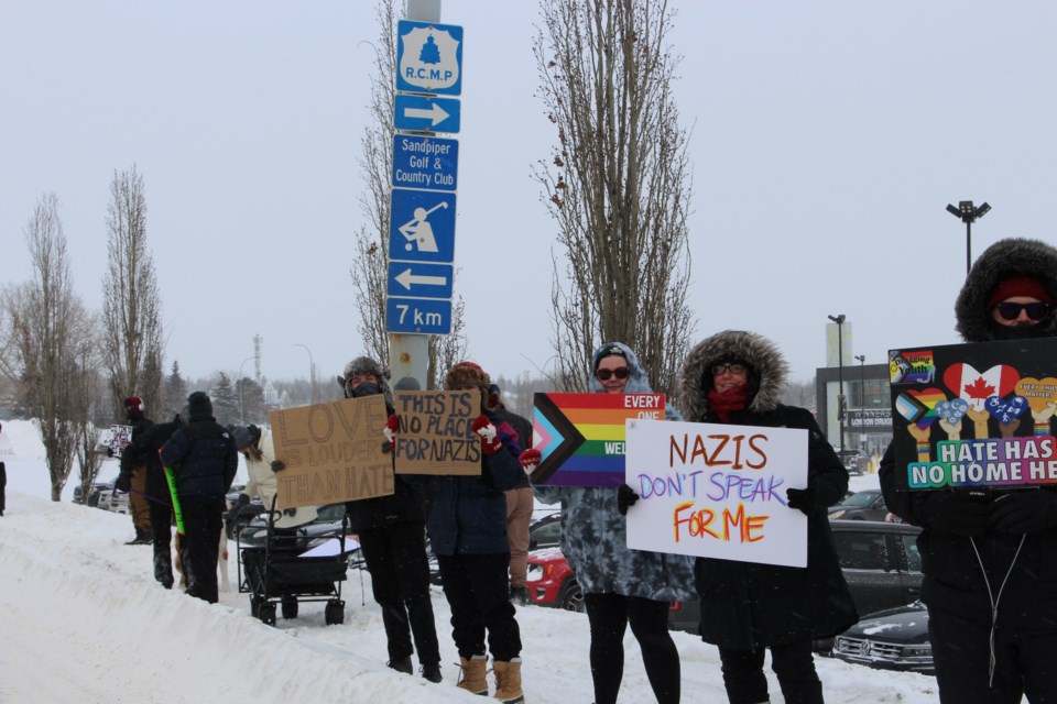 Supporters hold up anti-fascism signs at a protest held along St. Albert Trail on Feb. 2