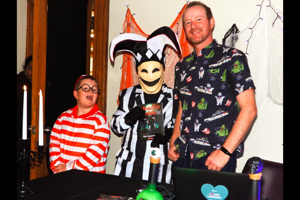 Canadian author Joel A. Sutherland took time to pose with fans Emerson and Mattias Skotniczny at the Stratford Public Library's Boo Bash and Zombie Walk on October 23.         