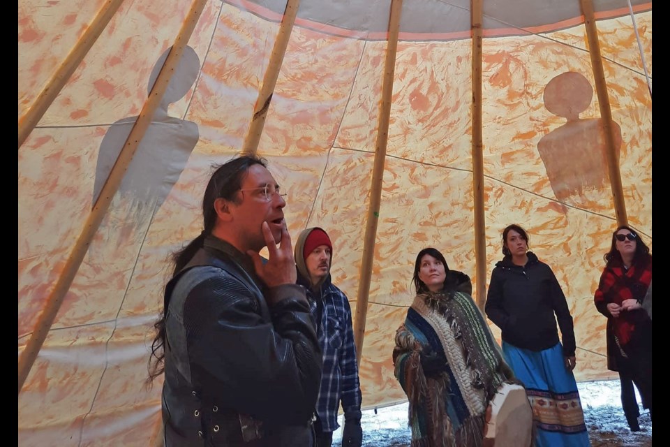 Christin Dennis welcomes visitors to the tipi at a prior event. He'll be hosting an open house event this weekend.