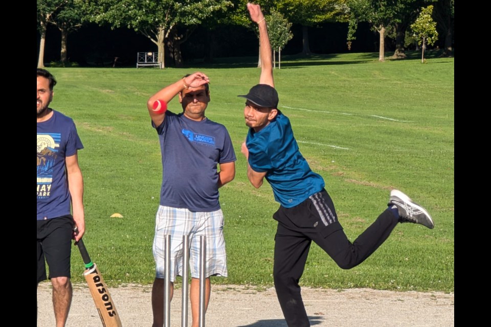 Abhi delivers a bowl during the early stages of the game, a weekly event for this group at the softball diamond just below the Stratford Festival.