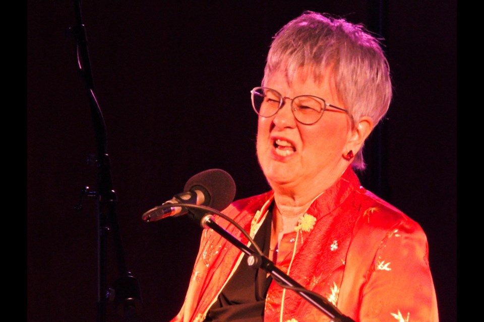 Judy Maddren scrunches up her face while reading the third stave of 'A Christmas Carol' Sunday, Dec. 8 at Avondale United Church.         