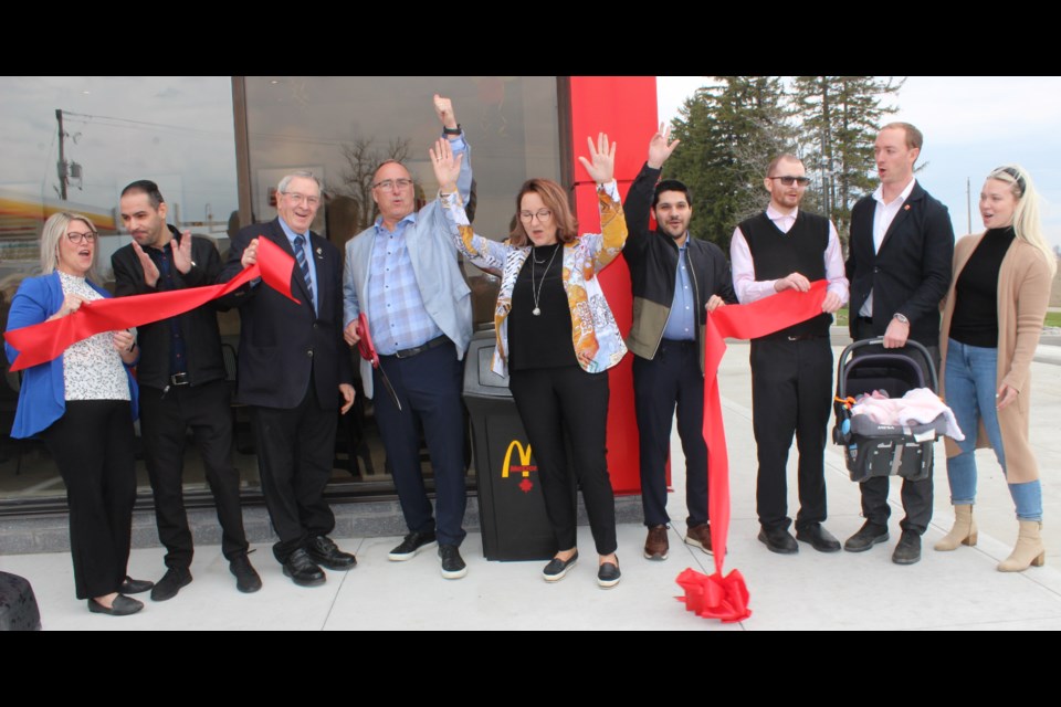 Cutting the red ribbon. 