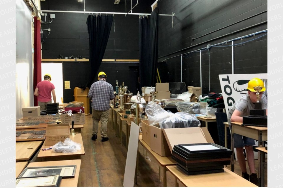 Summer students working to organize memorabilia for the open house.