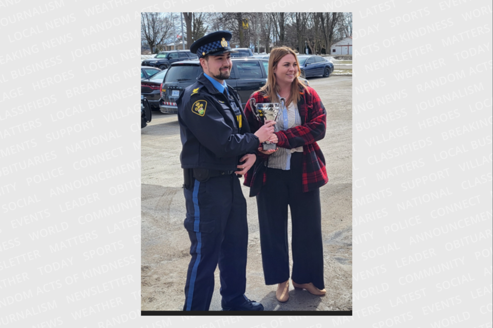 Perth County OPP acting auxiliary sergeant Brandon Cook received an award from Sky Dowe of Canadian Blood Services after the Perth County OPP won a blood drive with the Huron County OPP and Stratford Police Service.