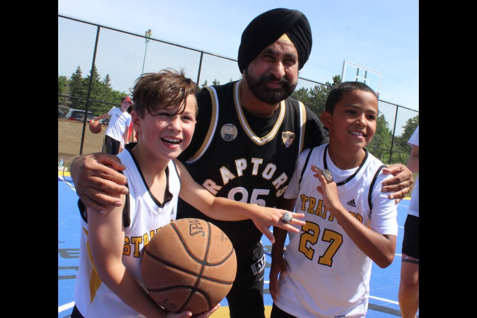 Raptors superfan Nav Bhatia with a few elated Stratford Revolution basketball players, Nash Riehl, left and Caleb Martin. 