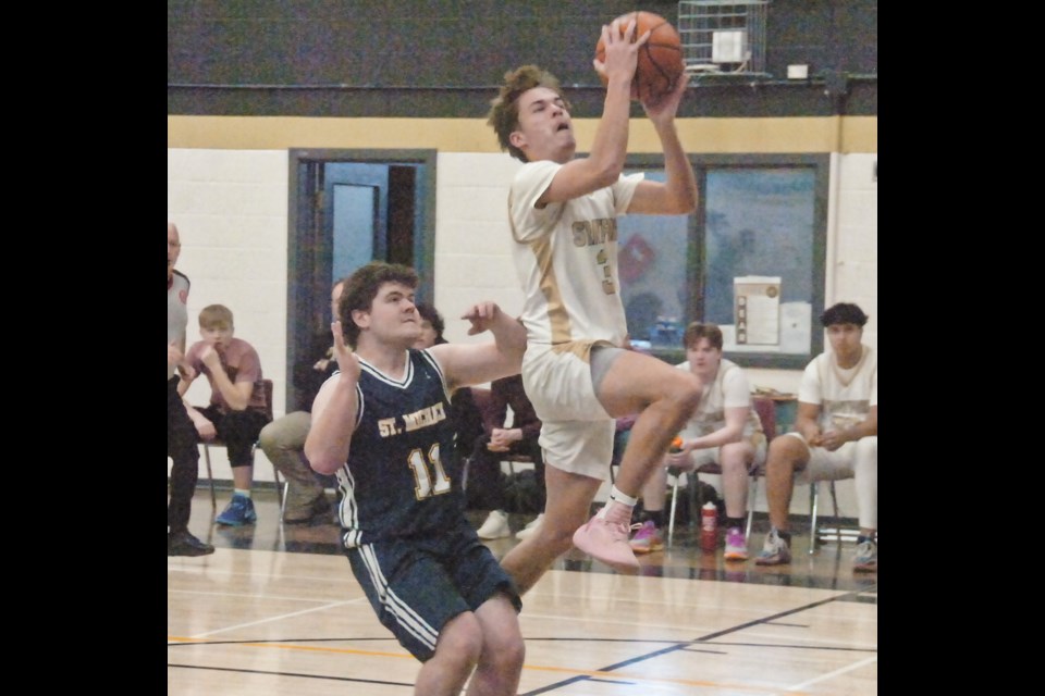 SDSS guard Andrew Leitch gets past a St. Mike's defender on his way to the basket.