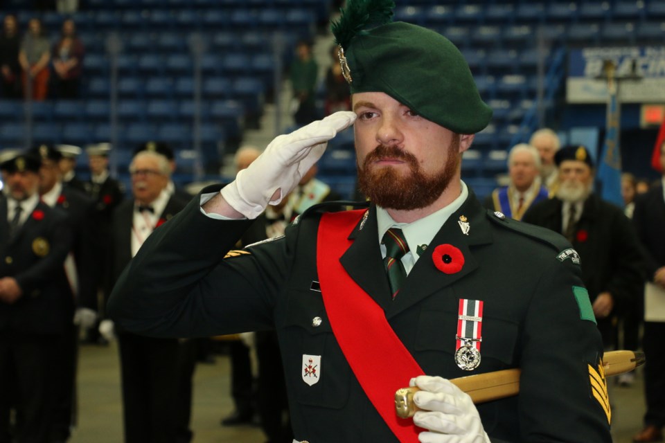 A soldier salutes during the playing of O Canada. 