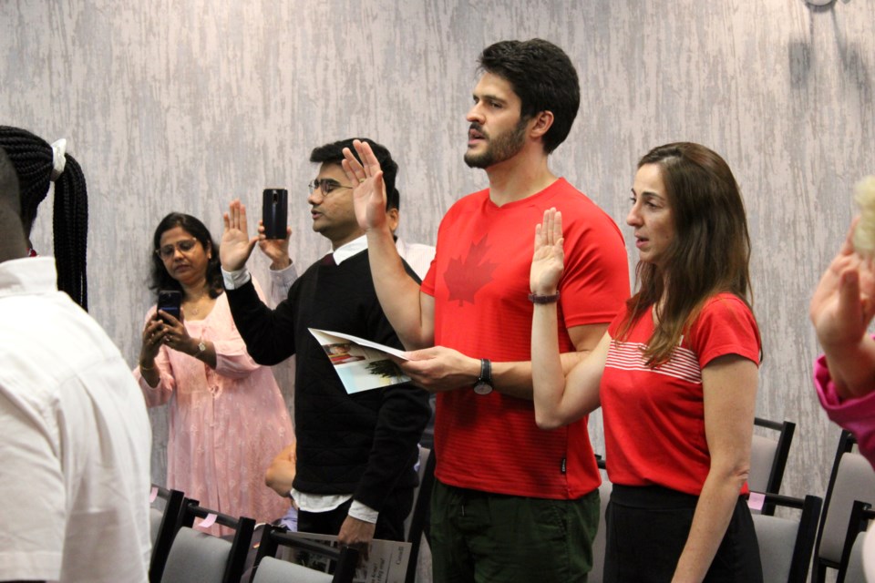 People take part in a Canada Day citizenship ceremony before the