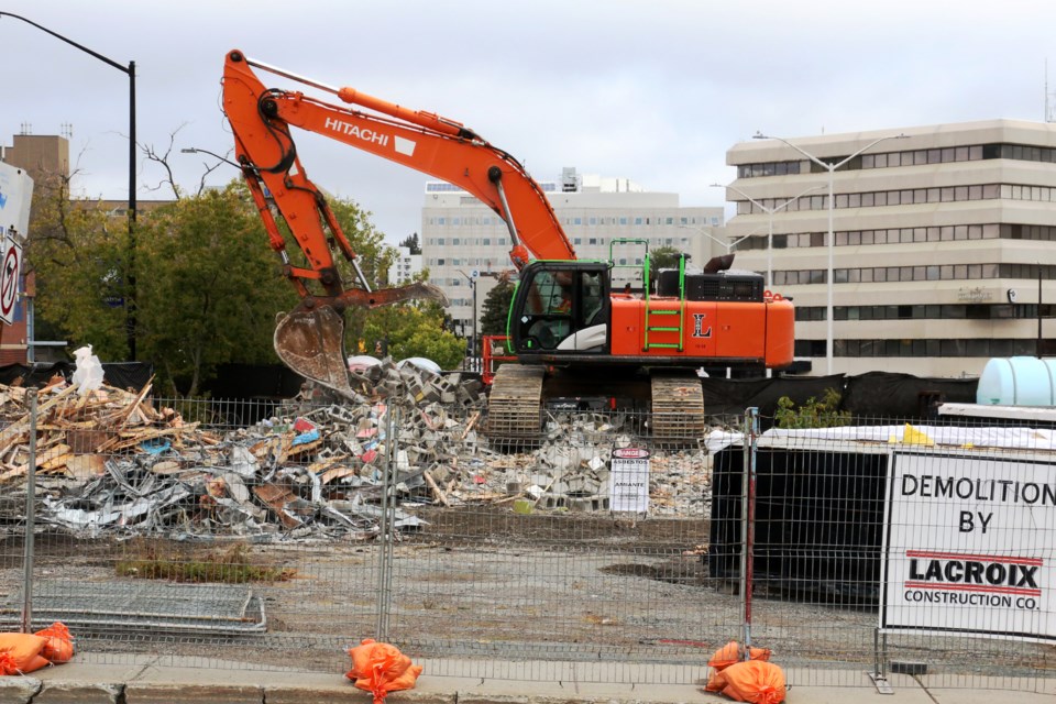 A large excavator continued Friday to demolish the Brûlerie Old Rock Roastery coffee venue on Minto Street and the nearby Doghouse Sports Bar and Eatery on Romanet Lane.