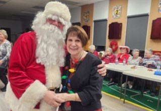 Mayor Jim Moffat dresses as Santa and stands with his mother in Dec. 2023.  