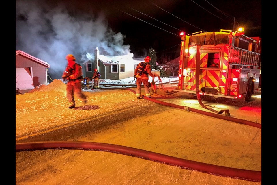 Thunder Bay Fire crews battle a fire at a Victor Street home Wednesday night. (Photo by James Brown).