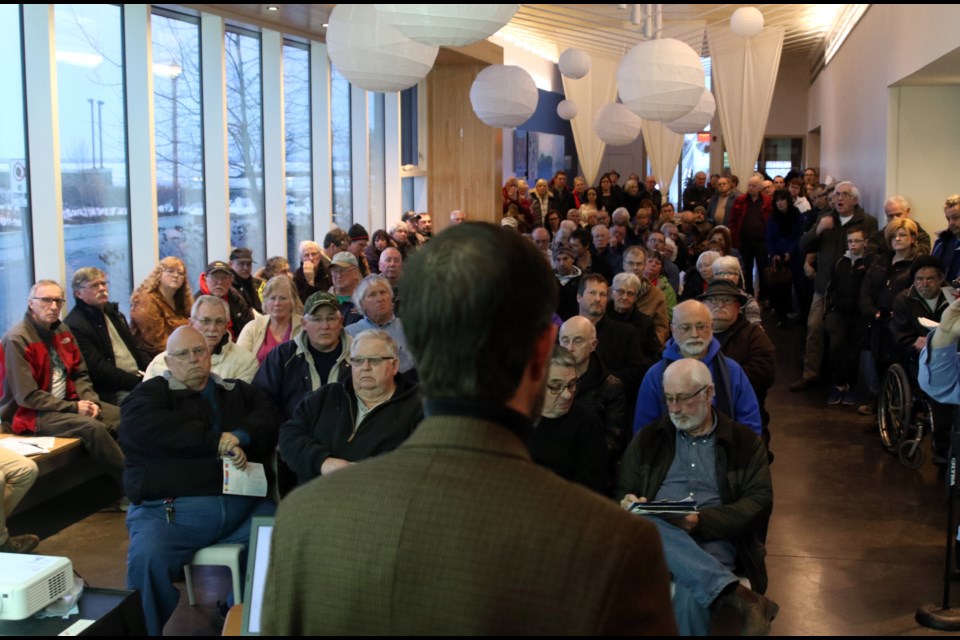 City development and emergency services general manager Mark Smith (front) faces a public consultation of 100 dissenting members of the public over the city's proposal to introduce paid parking at Marina Park.