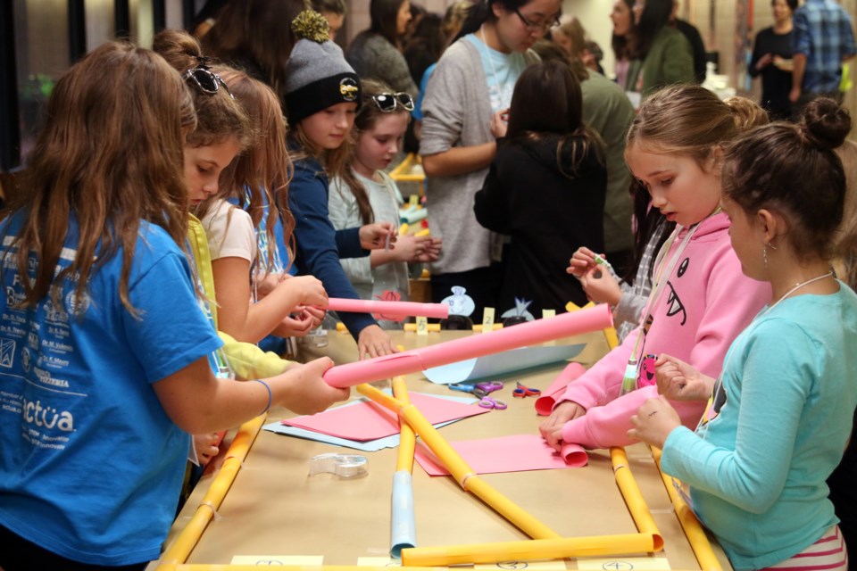 Girls in grade 7 to 10 practice some creative problem solving skills while building a miniature highway system during the Go Eng Girl program at Lakehead University on Saturday. 