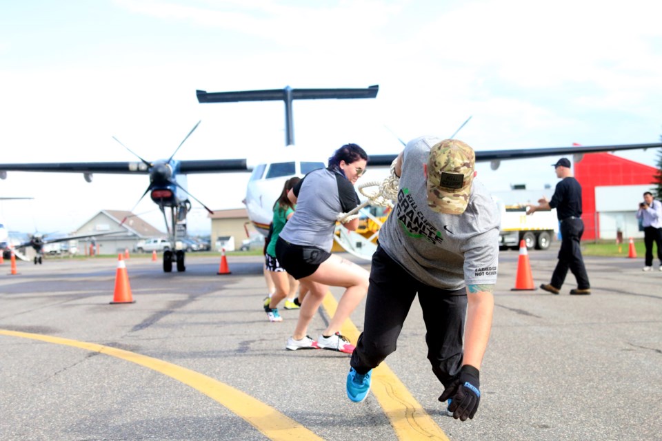 Hope Kuzma and Scott Dawson pull along with their team, Making Gaines and Pulling Planes, during the second annual Wasaya United Way Plane Pull. (Photos by Doug Diaczuk - Tbnewswatch.com). 