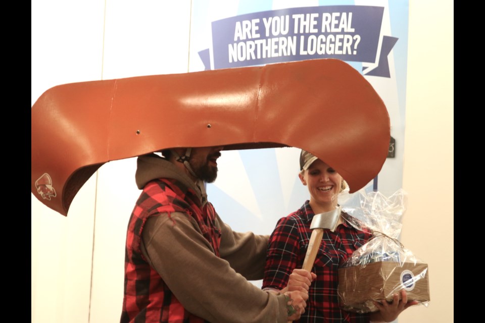 Carlie Pennock (right) receives her winning axe from Mr. Canoehead after being named the first the Sleeping Giant Brewing Company Real Northern Logger. (Photos by Doug Diaczuk - Tbnewswatch.com).  