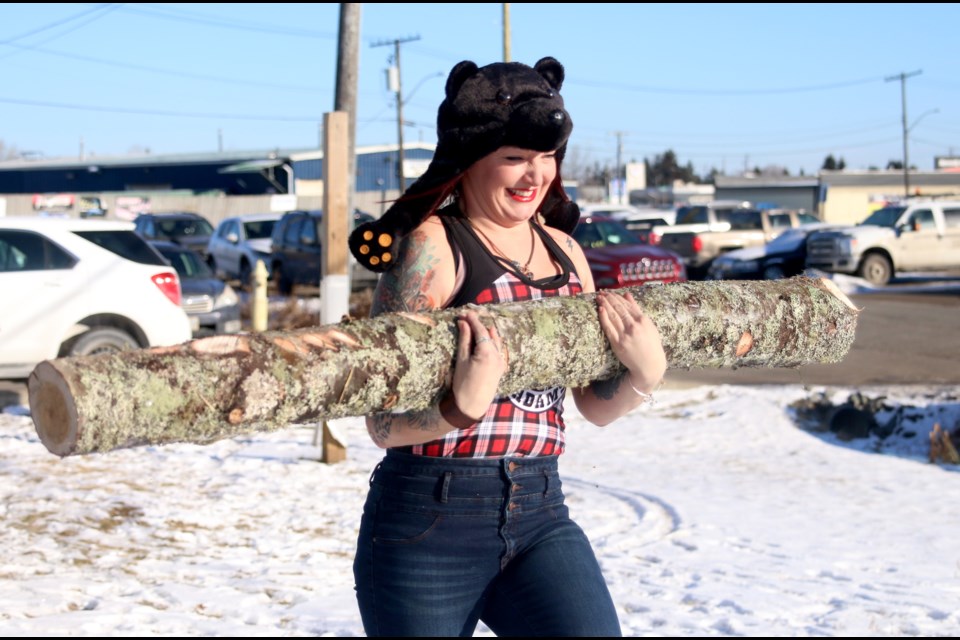 Patricia DePiero carries a log as part of a series of challenges during the search to find the Real Northern Logger at the Sleeping Giant Brewing Company. (Photos by Doug Diaczuk - Tbnewswatch.com). 