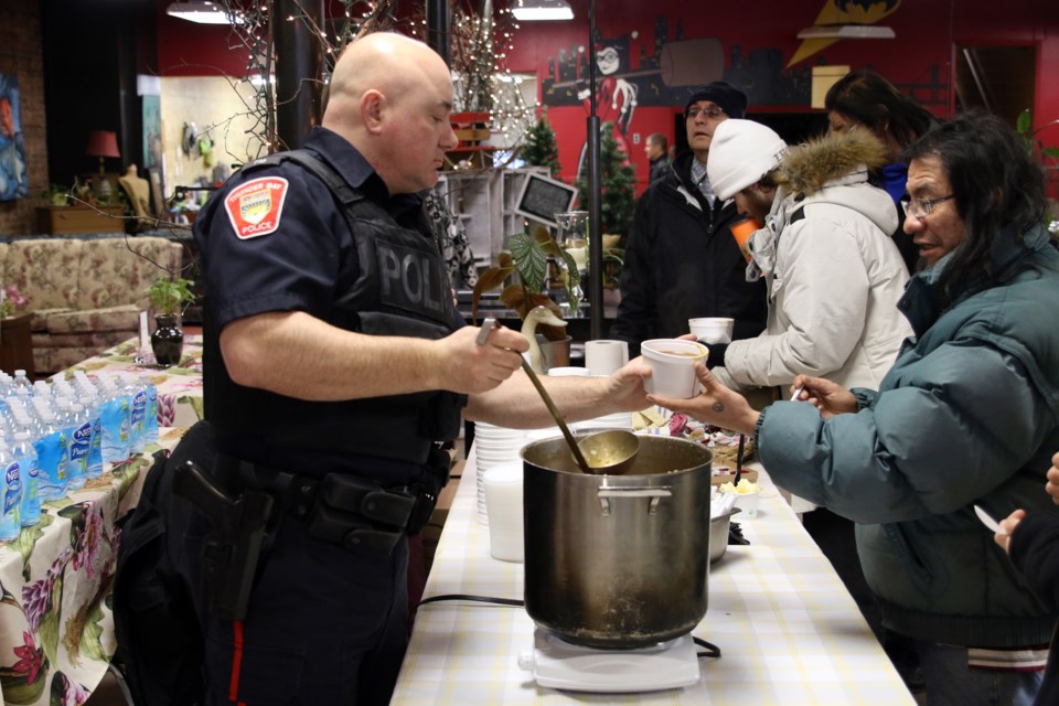 Const. Jason Kuoppa-Aho serves up free stew during the Together We Are Stronger Feast in downtown Fort William on Saturday. 