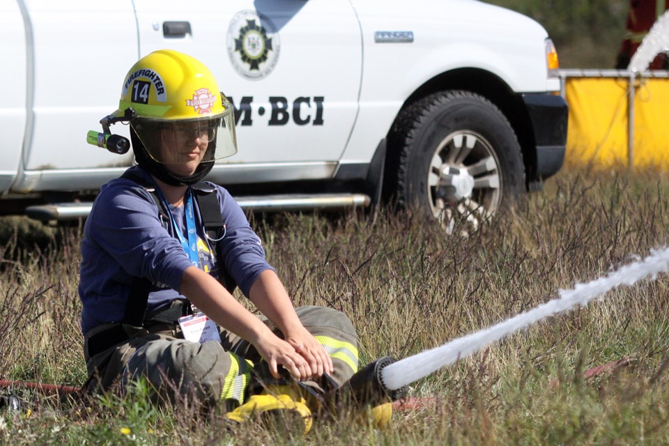 Erica Parent operates a hose at the Thunder Bay fire training centre during FireCon on Friday, September 7, 2018. (Matt Vis, tbnewswatch.com)