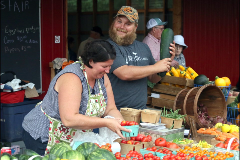 Thomas Groenheide (right) of Tarrymore Farms and Shannon Vanlenthe, The Squash Queen, were busy selling locally grown produce at the 106th Hymers Fall Fair on Sunday. (Photos by Doug Diaczuk - Tbnewswatch.com).   