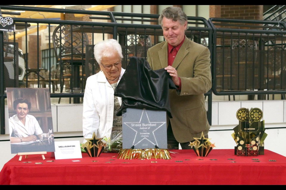 Joan Stone, former housekeeper for Sheila Burnford (left) and Ron Harpelle, unveil Burnford's tile to be included on the city's Walk of Fame at Victoriaville Mall. (Photos by Doug Diaczuk - Tbnewswatch.com). 