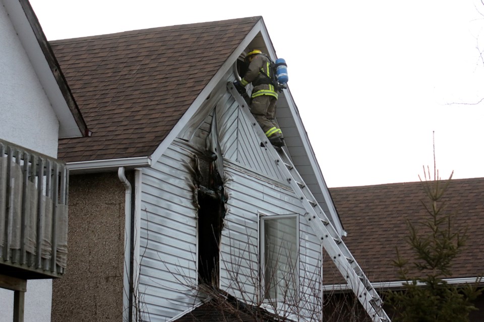 A Thunder Bay Fire Rescue firefighter inspects the aftermath of a fire at a Wiley Street home on Friday, April 5, 2019. (Leith Dunick, tbnewswatch.com)