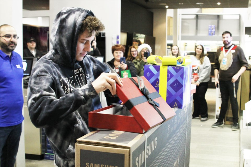 Alex Bingham opens some surprise gifts as part of his Make a Wish experience. (Photos by Ian Kaufman, Tbnewswatch.com)