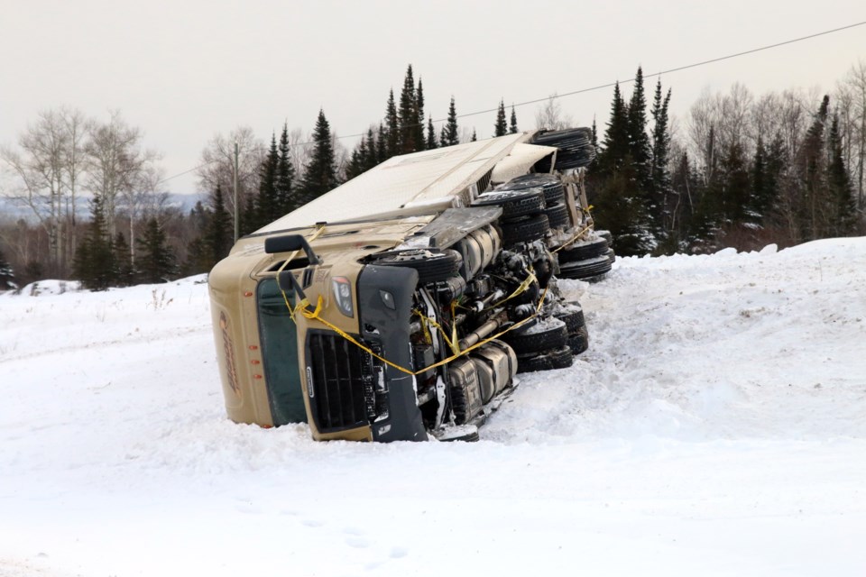 A transport truck rolled over onto its side after sliding off Highway 17 just north of the Terry Fox Monument. 