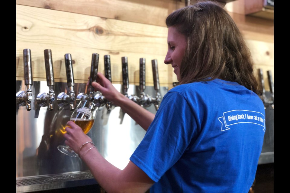 Sleeping Giant Brewing Company retail tap room manager, Elke Cullis, pours a pint to kick off the Craft Cares movement. (Photos supplied).  