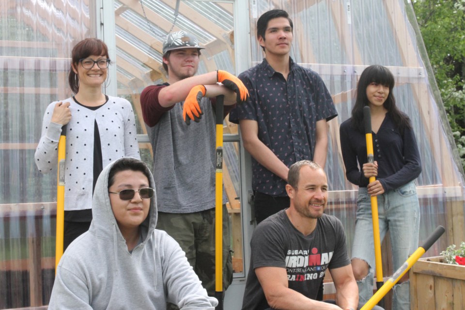 Jocelyn Carobelli (top left), Liam Myers, Daniel Ironsand, Dana Shonias, Logan Metansinine (bottom left), and Peter Stickel in front of the Gateway garden at the Boys and Girls Club. (Michael Charlebois, tbnewswatch)