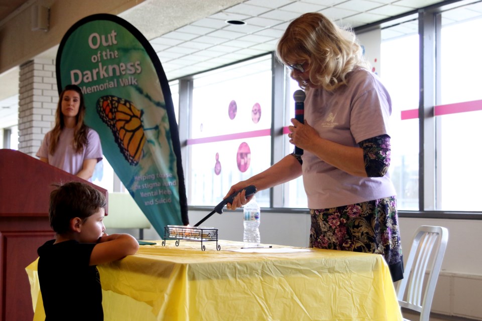 Margaret Hajdinjak, organizer of the Annual Out of the Darkness Memorial Walk on Sunday, lights candles for those lost to suicide. (Photos by Doug Diaczuk - Tbnewswatch.com). 