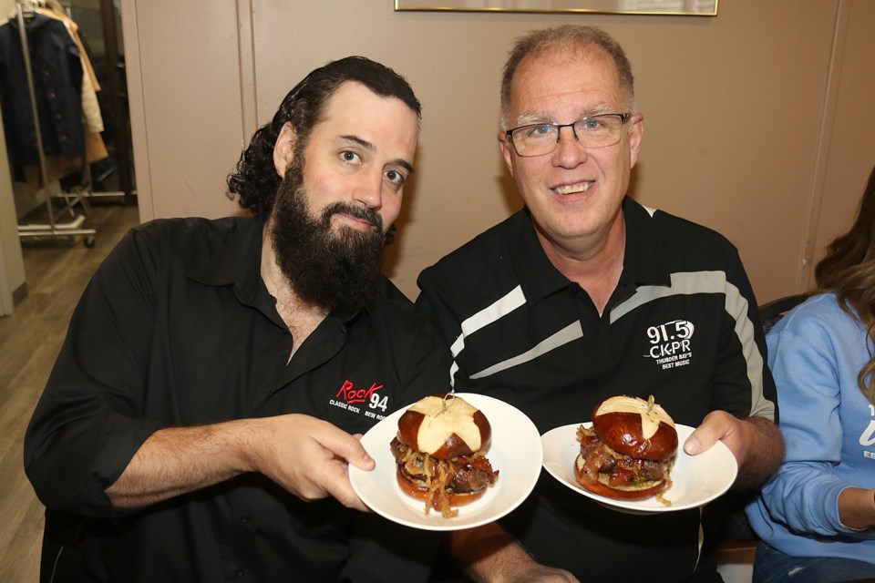 Rock 94's Dave Steen (left) and CKPR's Bill Hogan are two of five Novemburger ambassadors on Friday, Nov. 1, 2019 helping the United Way of Thunder Bay launch it's burger-themed fundraiser at Daytona's. (Leith Dunick, tbnewswatch.com)