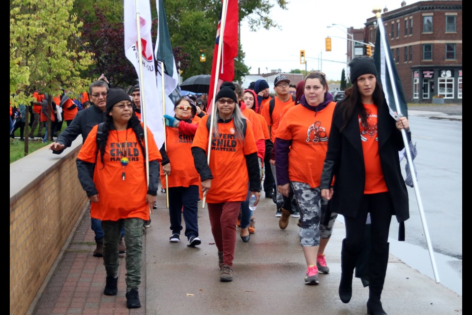 Residential school survivor, Sarahjean Cromarty (middle) leads a march to the former site of the St. Joseph's Residential School during Orange Shirt Day. (Photos by Doug Diaczuk - Tbnewswatch.com). 