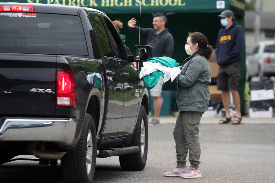 Students and parents picked up graduation caps and gowns on Monday, June 8, 2020 in preparation for a virtual grad later in the month. (Leith Dunick, tbnewswatch.com)