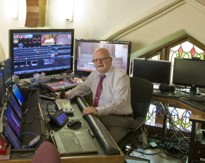 Rev. Randy Boyd of Trinity United Church sits in front of equipment used for an online service that occurred Mar. 22, 2020 (submitted photo)