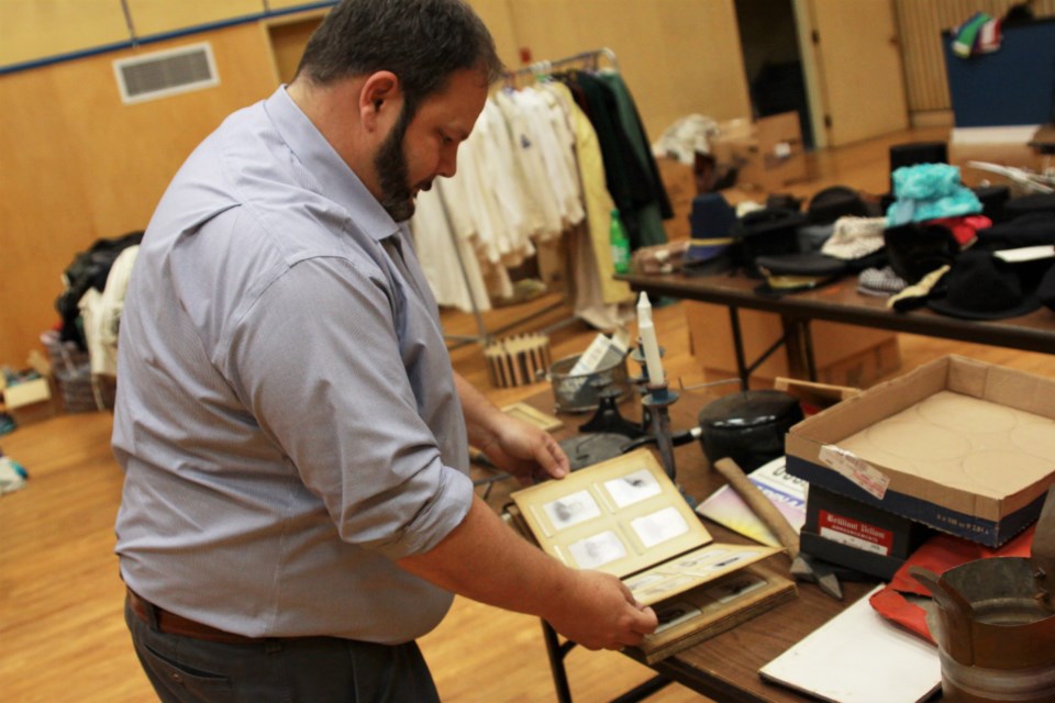 Derek Parks, a former board member of the Finlandia Association, looks through some of the historic items volunteers are working to find homes for. (Photos by Ian Kaufman, tbnewswatch.com)