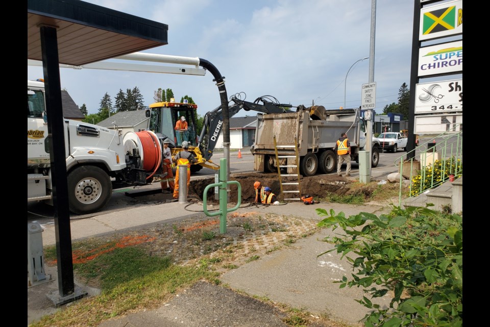 A repair crew excavated Red River Road on Wed. July 14, 2021 (TBNewswatch photo)