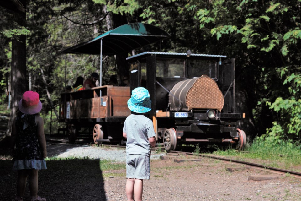 Children wait for a ride on the Muskeg Express at Centennial Park on Friday.