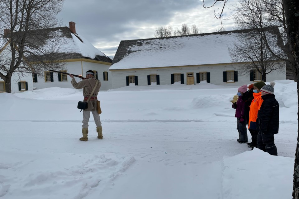 Campers learning about muskets