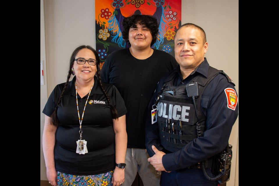 Cst. Larry Baxter poses with Matawa Education Ctr. student Damien Achneepineskum and Matawa Education and Care Centre mental health coordinator Malinda Staal (MECC/TBPS photo)