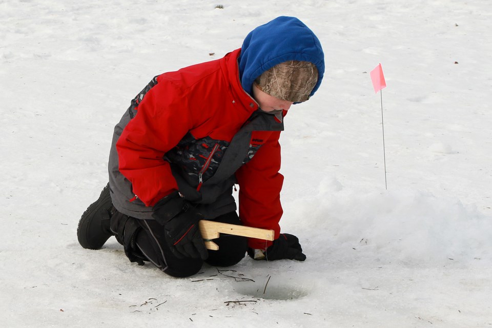 Reid Parsons, 9, tries his hand at ice fishing on Monday, Feb. 20, 2023, during Family Day activities at the Thunder Bay waterfront. (Leith Dunick, tbnewswatch.com)