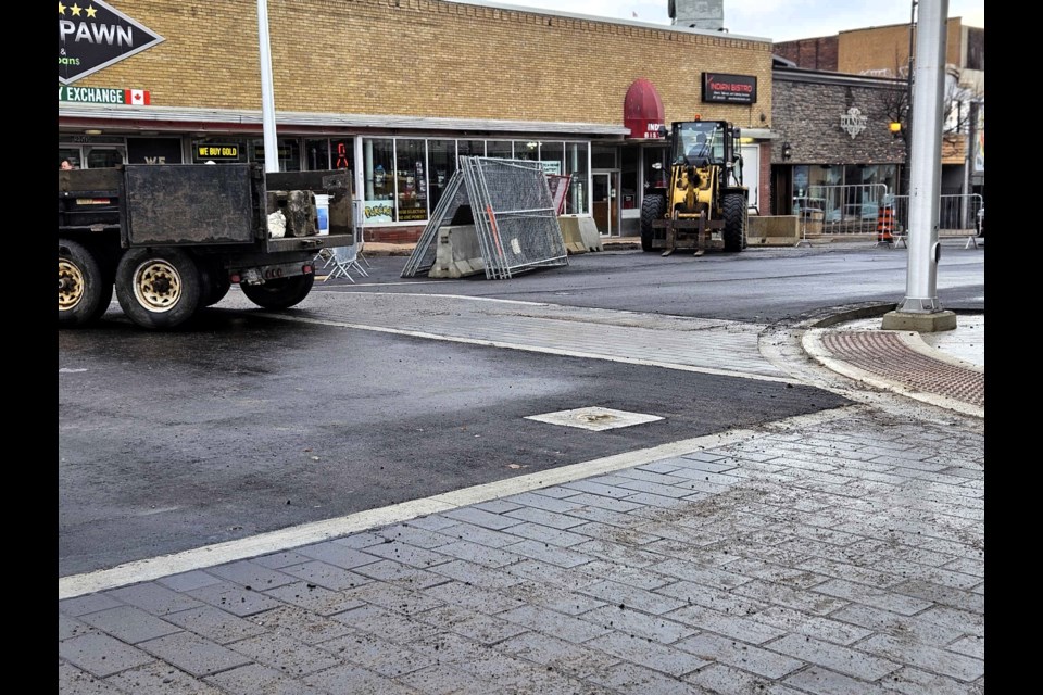 Temporary asphalt at the intersection of Red River Rd & Court St