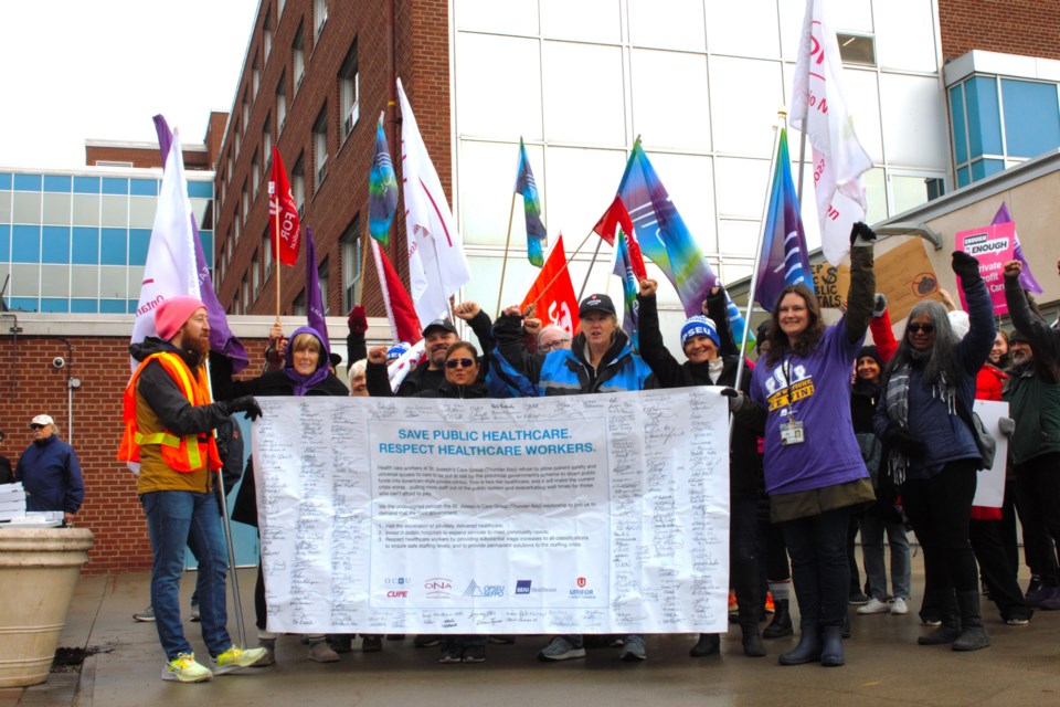 Dozens of local health care workers rallied outside of St. Joseph's Hospital against Bill 60 on Friday.