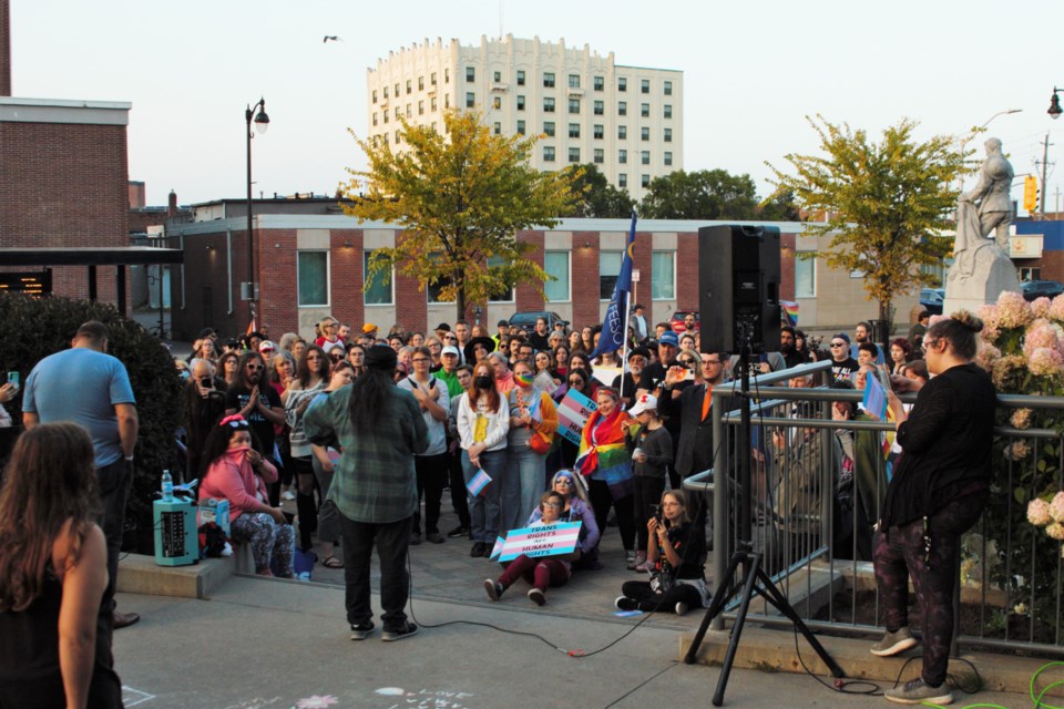 Over 200 people joined a "healing rally" at city hall on Wednesday, responding to a march earlier in the day that called for schools to be less welcoming to LGBTQ+ youth.