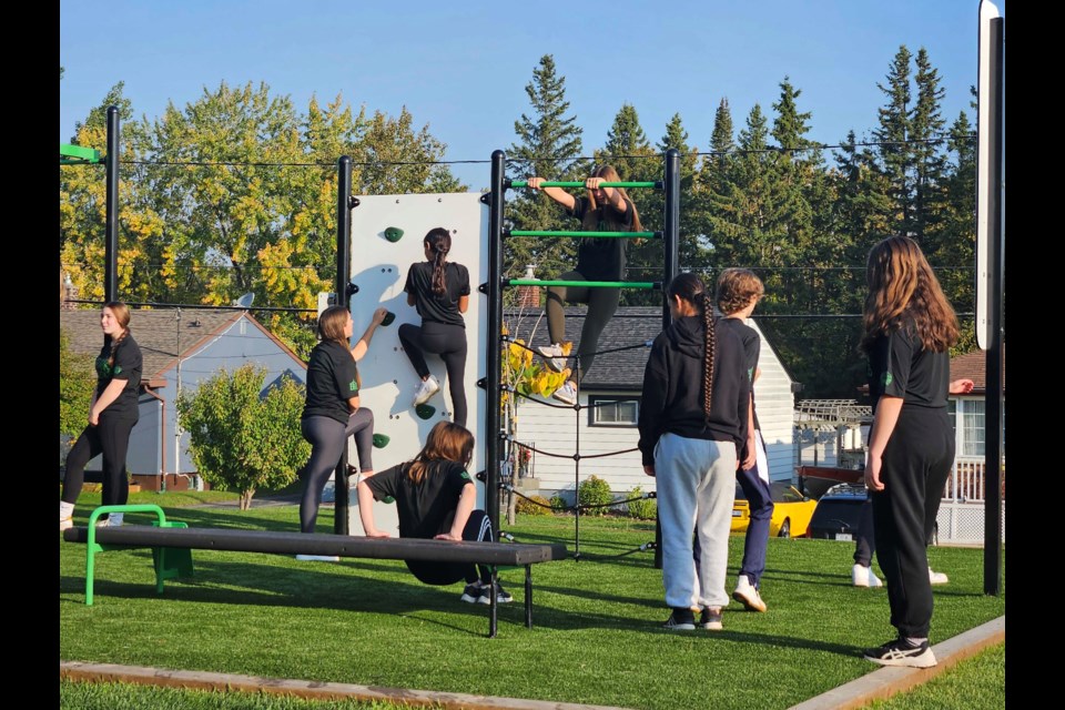 Students use the new exercise equipment on the newly installed turf at Bishop Gallagher Sr. Elementry School