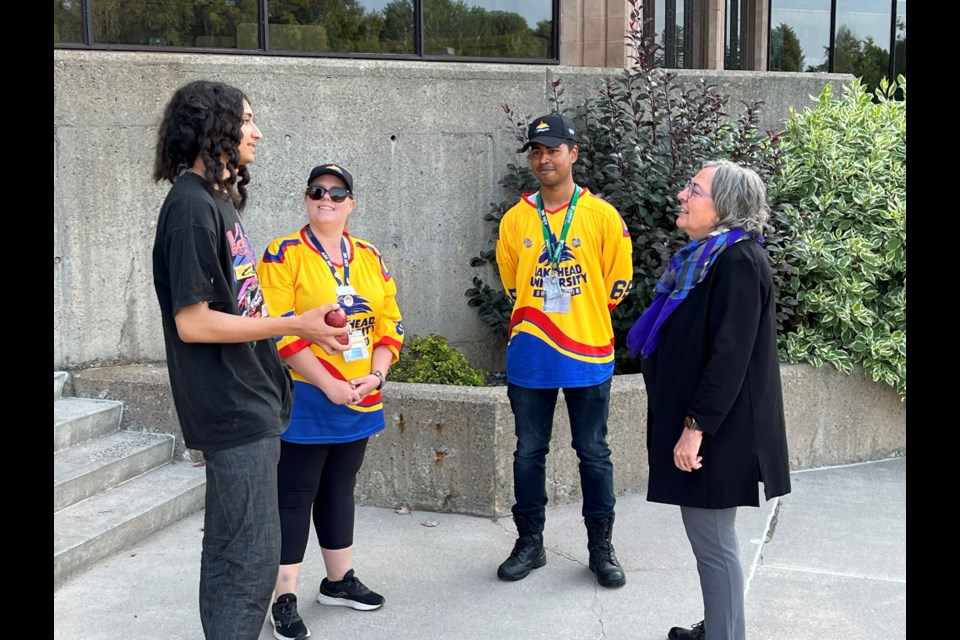 Lakehead University president and vice-chancellor Gillian Siddall, right, speaks to a group of people on campus on Friday.